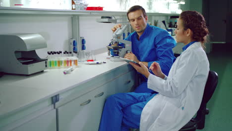 Chemistry-scientist-team-working-with-tablet-pc.-Chemist-woman-with-tablet